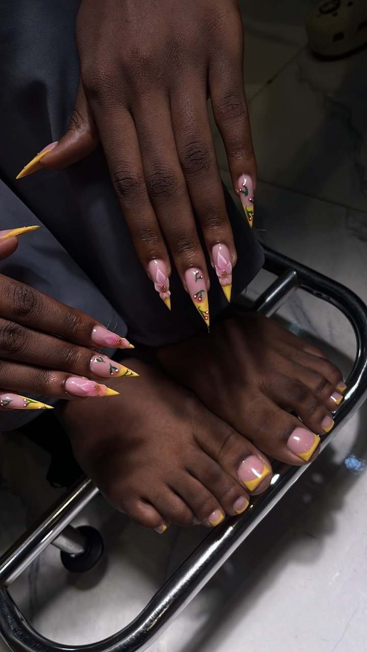 Nail art by Zoba Beauty β yellow French tips with floral detail on hands and feet