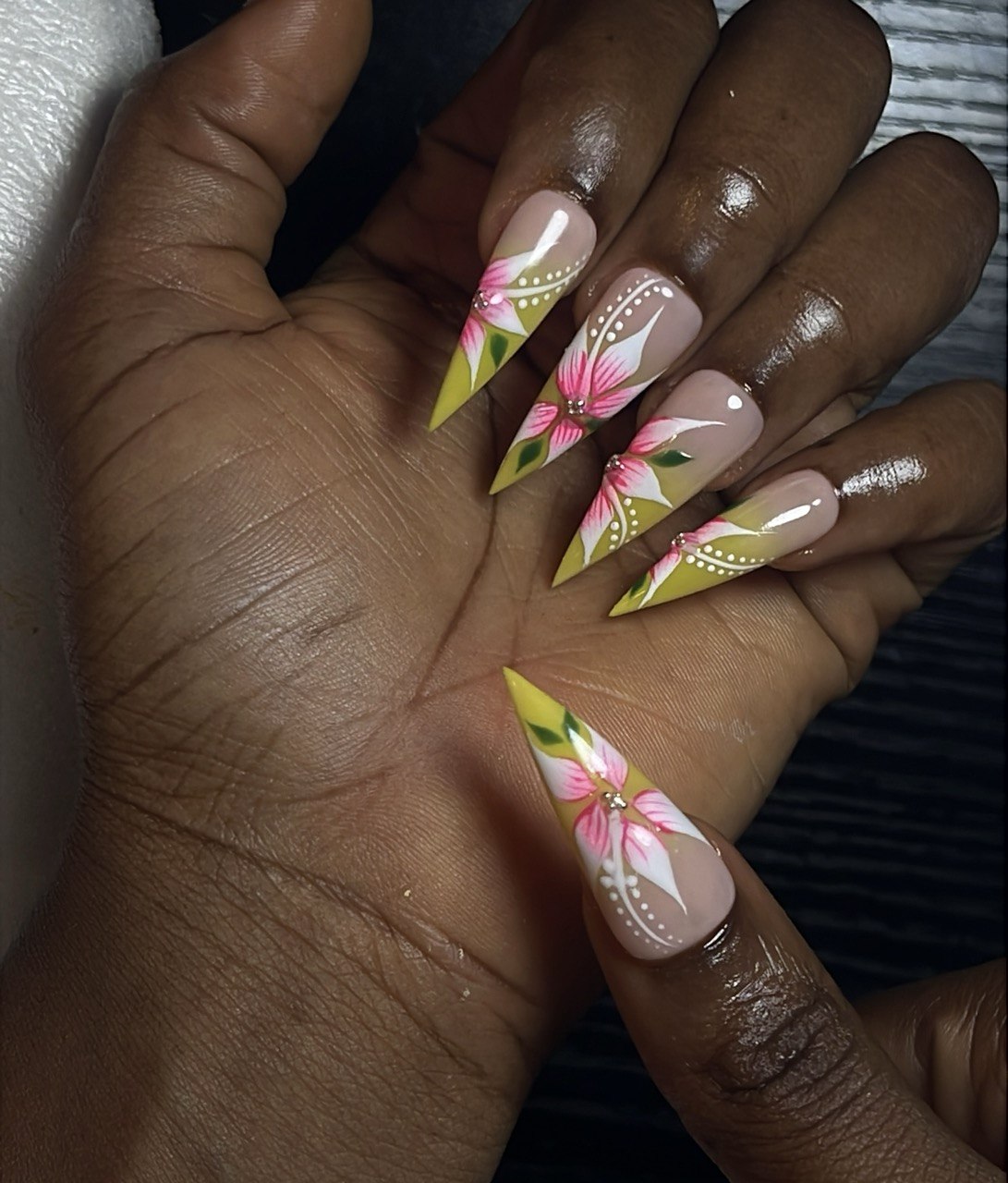 Nail art by Zoba Beauty β yellow stiletto set with pink and white floral design