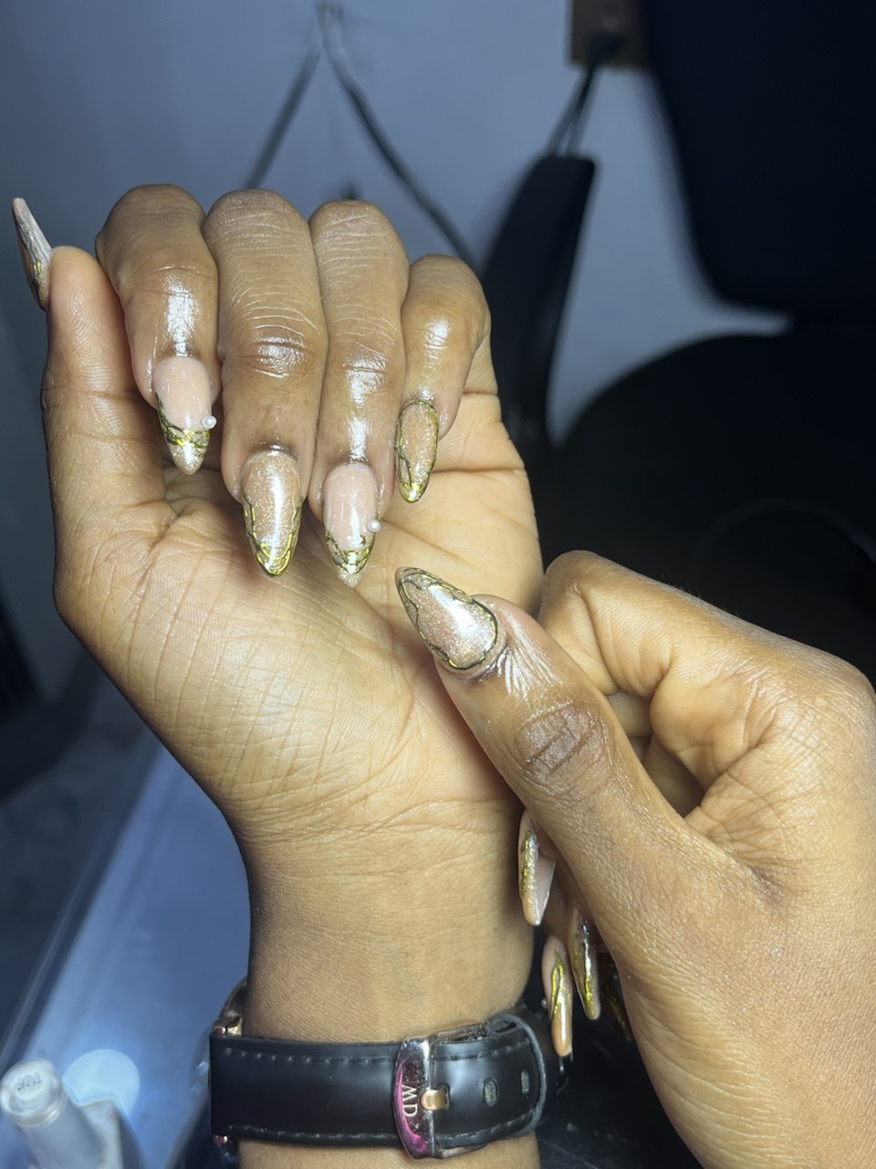 Nail art by Zoba Beauty β gold glitter almond-shaped nails with line art
